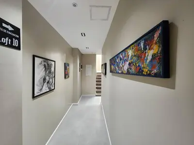 a hallway with a large flat screen tv on a wall at Loft 10, Suite Parque del Poblado 204 in Medellín