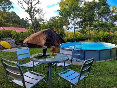 two glasses of beer on a table next to a pool at Finca Villa Laura in Támesis