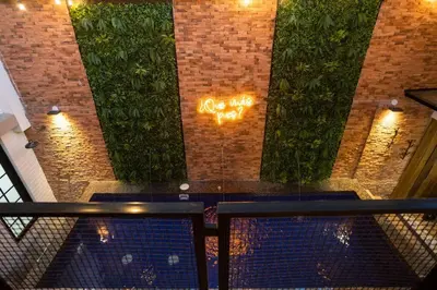 a view of a brick wall with graffiti on it at ENCANTO - Provenza Private Villa with Heated Pool & Hot Tub Encanto NOWA in Medellín