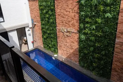 a building with a green hedge on the side of it at ENCANTO - Provenza Private Villa with Heated Pool & Hot Tub Encanto NOWA in Medellín