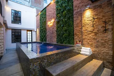 a swimming pool in the middle of a building at ENCANTO - Provenza Private Villa with Heated Pool & Hot Tub Encanto NOWA in Medellín