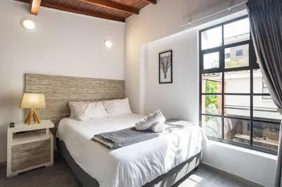 a bedroom with a bed and a large window at ENCANTO - Provenza Private Villa with Heated Pool & Hot Tub Encanto NOWA in Medellín