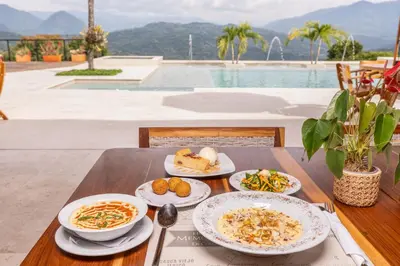 a wooden table with plates of food on it at Fina Estampa Country Hotel - Mayores de 10 años in Támesis