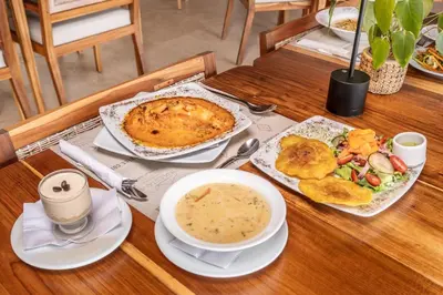 a table with a plate of food and a bowl of soup at Fina Estampa Country Hotel - Mayores de 10 años in Támesis