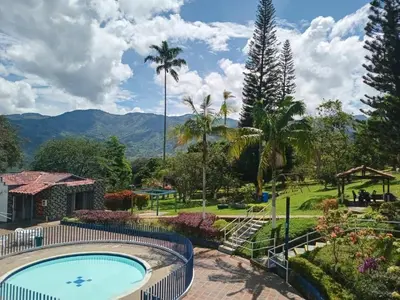 a resort with a swimming pool and a playground at Yarumito Finca Hotel l Cabaña Pensamiento in Barbosa