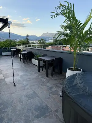 a patio with tables and chairs on a roof at Vive Medellin 401 in Medellín