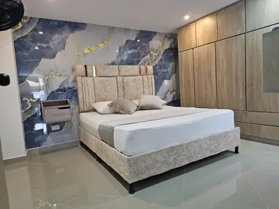 a bedroom with a bed with a mural on the wall at Vive Medellin 401 in Medellín