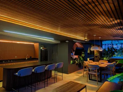 a restaurant with a bar with blue chairs and tables at Apartamento - penthouse cyan in Medellín