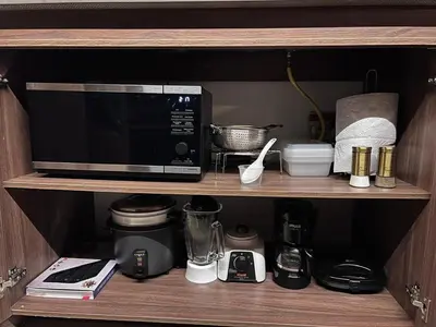 a microwave and other kitchen items on a shelf at Apartamento - penthouse cyan in Medellín