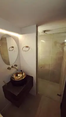 a bathroom with a sink and a shower at Apartamento - penthouse cyan in Medellín