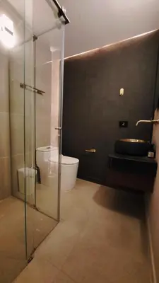 a bathroom with a glass shower and a toilet at Apartamento - penthouse cyan in Medellín