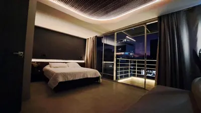 a bedroom with a bed and a large window at Apartamento - penthouse cyan in Medellín