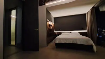 a bedroom with a bed and a large window at Apartamento - penthouse cyan in Medellín