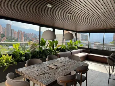 a dining room with a large table and chairs at Apartamento - penthouse cyan in Medellín
