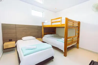 a bedroom with two bunk beds and a ladder at Hotel Luna Verde in Doradal