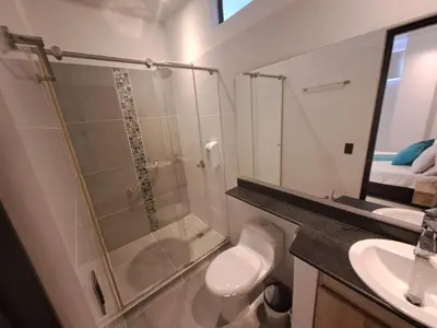 a bathroom with a shower and a toilet and a sink at Hotel Luna Verde in Doradal