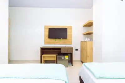 a hospital room with two beds and a television at Hotel Luna Verde in Doradal
