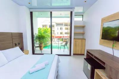 a bedroom with a bed and a large window at Hotel Luna Verde in Doradal