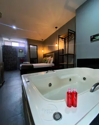 a large bath tub in a bathroom with a room at Hotel Panorama Urban Medellin in Medellín