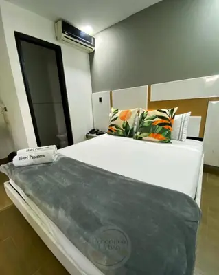 a bedroom with a large bed in a room at Hotel Panorama Urban Medellin in Medellín