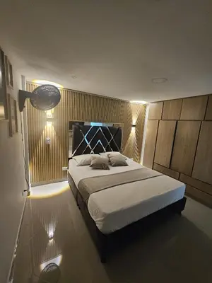 a bedroom with a large bed with lights on it at Vive Medellin 302 in Medellín