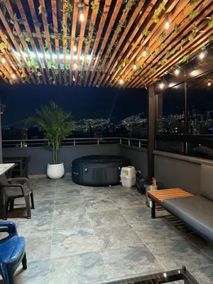 a rooftop patio with a hot tub and a city skyline at Vive Medellin 302 in Medellín