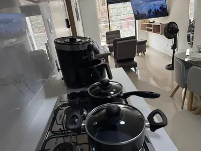 a kitchen with a stove with pots and pans on it at Vive Medellin 302 in Medellín