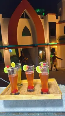 a tray with four drinks on a table at Hotel y Termales Castillo Del Lago Guatape in Horizonte