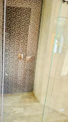 a shower with a glass door in a bathroom at Hotel y Termales Castillo Del Lago Guatape in Horizonte