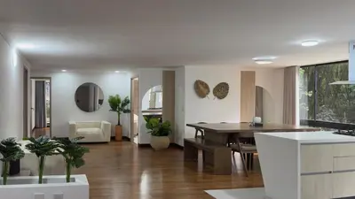 a kitchen and living room with a table and chairs at 4BR 240 m² Fully Refurbished El Tesoro in Medellín