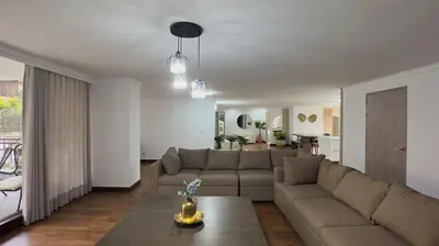 a living room with a couch and a table at 4BR 240 m² Fully Refurbished El Tesoro in Medellín