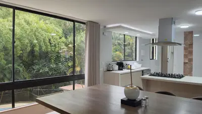 a kitchen and dining room with a large window at 4BR 240 m² Fully Refurbished El Tesoro in Medellín