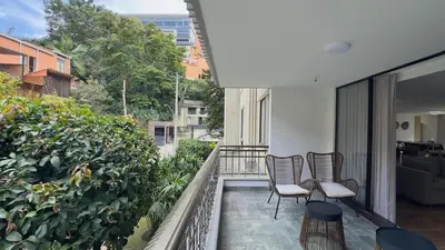 a balcony with chairs and plants on a building at 4BR 240 m² Fully Refurbished El Tesoro in Medellín