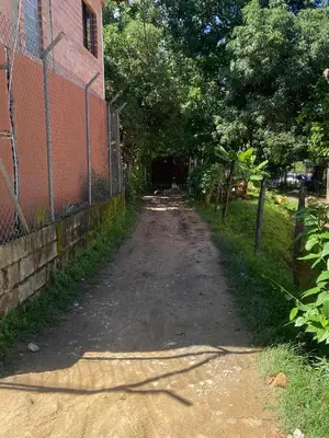 a dirt road next to a fence next to a building at Finca Villa Dudia in Sopetran