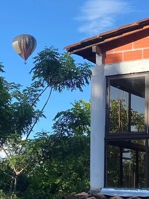 a hot air balloon flying over a house at Finca Villa Dudia in Sopetran