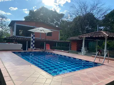 a swimming pool in front of a house at Finca Villa Dudia in Sopetran