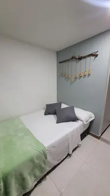 a bedroom with a large white bed in a room at El Amañadero Paisa in Envigado