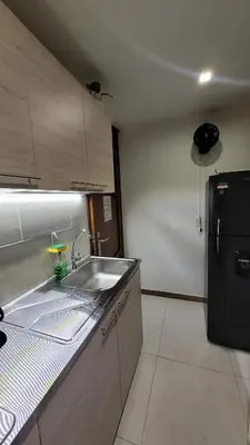 a kitchen with a sink and a black refrigerator at El Amañadero Paisa in Envigado