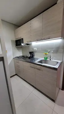 a kitchen with wooden cabinets and a sink at El Amañadero Paisa in Envigado