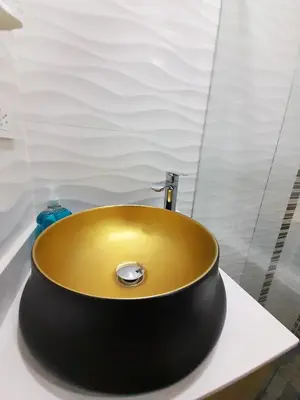 a yellow sink sitting on a counter in a bathroom at Medellin cómodo apartaestudio 503 in Medellín