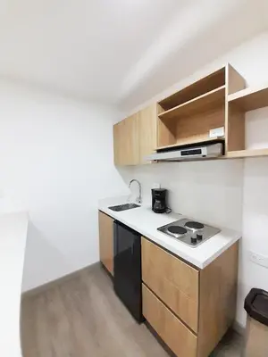 a small kitchen with a sink and a stove at Medellin cómodo apartaestudio 503 in Medellín