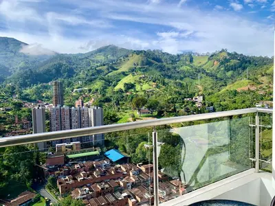 a balcony with a view of a city and mountains at Piso27 PROMO! LUJOSO APARTAMENTO, PARKING Y ZONAS HUMEDAS in Sabaneta
