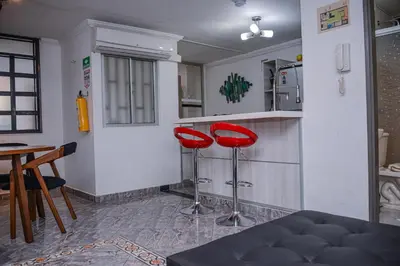 a kitchen with two red stools in a room at Apartment Carrera 301 in Medellín