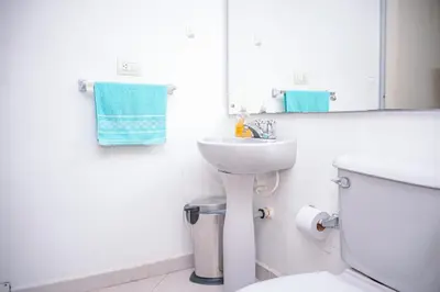 a bathroom with a sink and a toilet and a mirror at Apartment Carrera 301 in Medellín