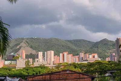 a city with buildings and mountains in the background at Apartment Carrera 301 in Medellín
