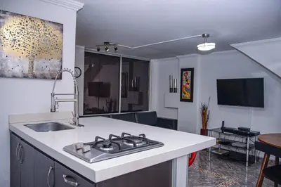 a kitchen with a sink and a stove top oven at Apartment Carrera 301 in Medellín