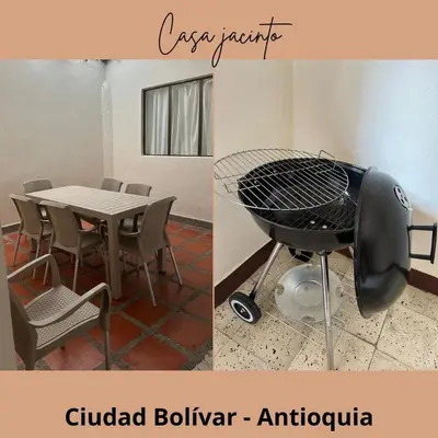 a picture of a grill and a table and chairs at Casa Jacinto in Ciudad Bolívar