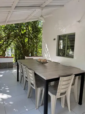 a wooden table and chairs on a patio at Acogedora cabaña en la Pintada in La Pintada