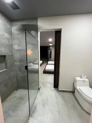 a bathroom with a shower and a toilet and a mirror at Finca Luxury en Doradal Antioquia in Puerto Triunfo