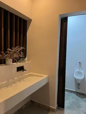 a bathroom with a sink and a urinal on the wall at Finca Luxury en Doradal Antioquia in Puerto Triunfo